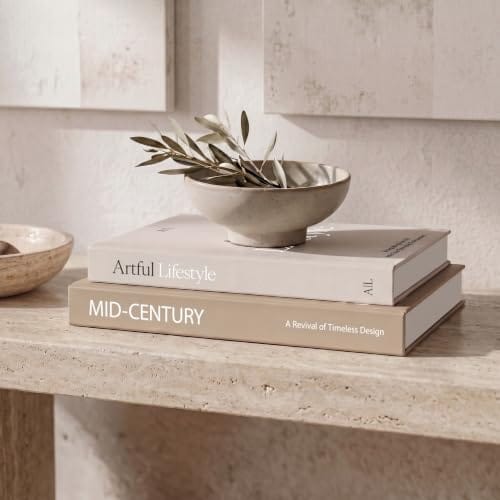 Two neutral ZICOTO decorative book boxes styled on a stone table