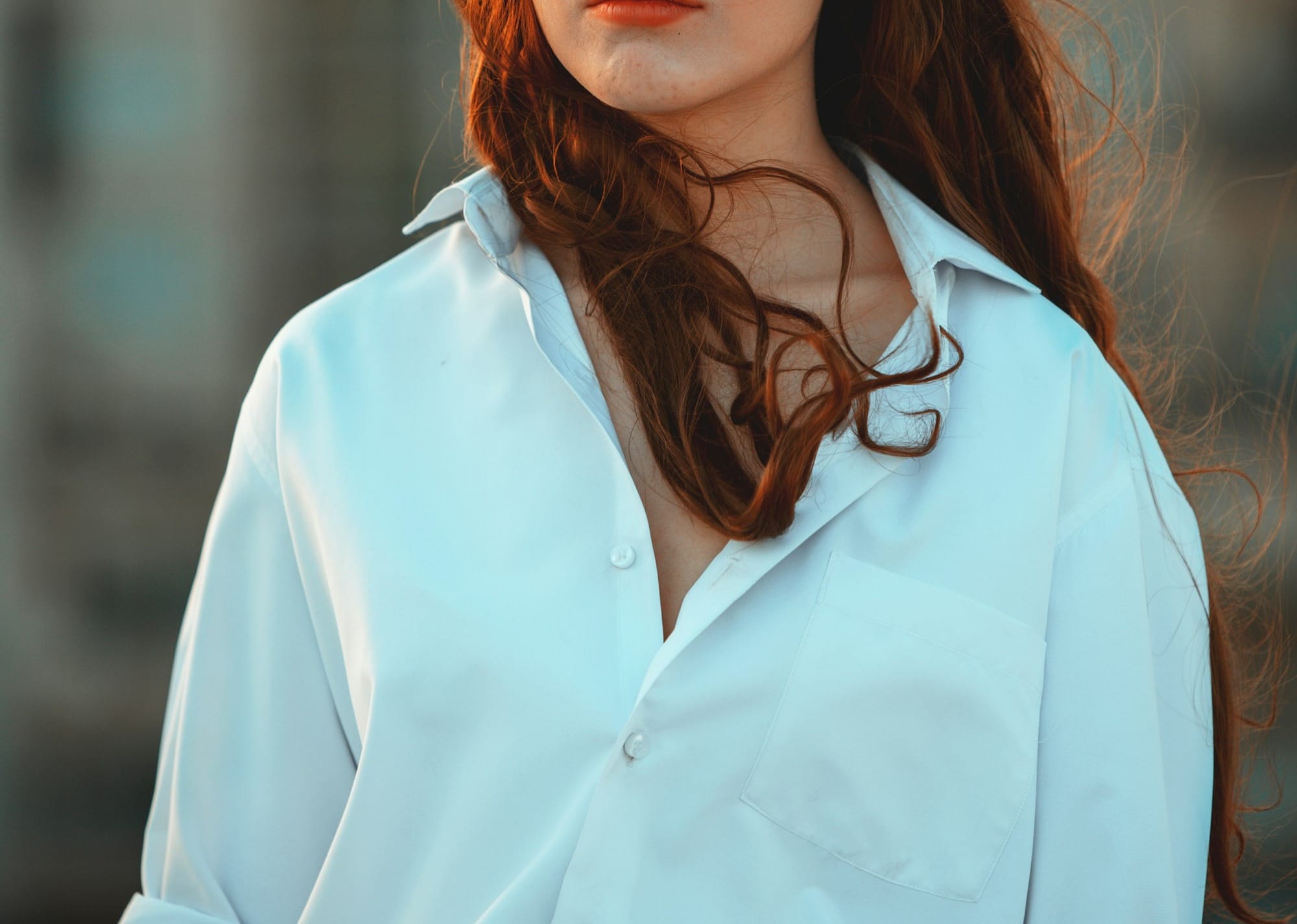 woman in white button-up long-sleeved shirt smiling