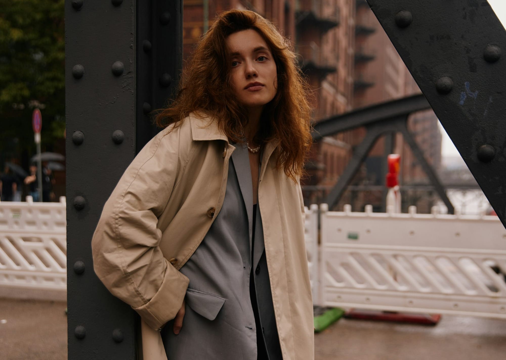 Woman wearing timeless trench coat and neutral tailored outfit