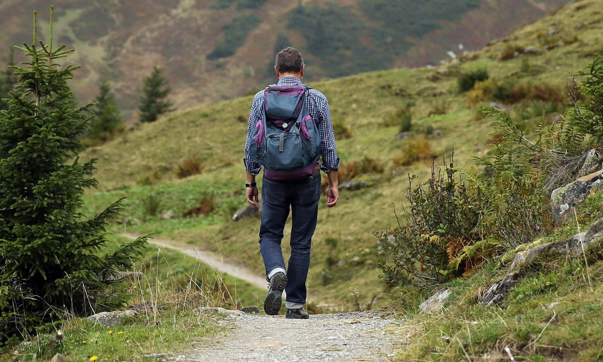Photo of a man walking down a path
