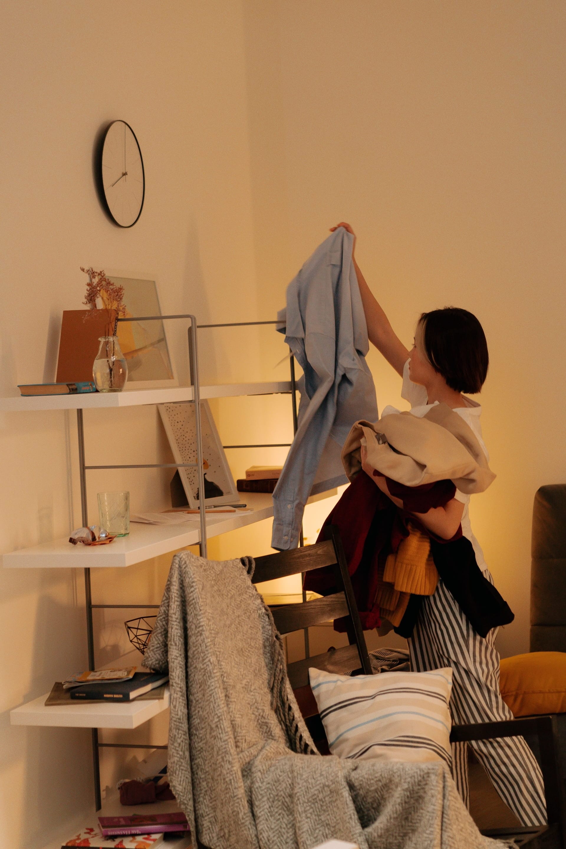 A chair lost beneath a mountain of clothes