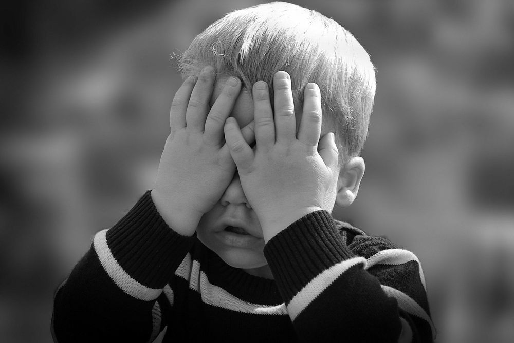 Photo of a child hiding their face