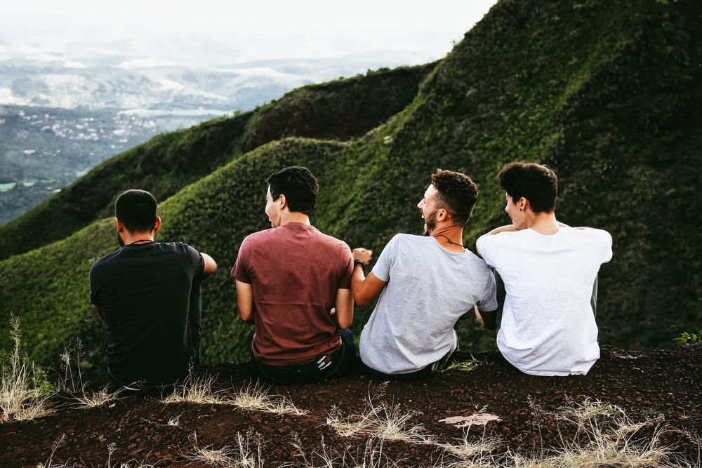 Photo of a group of friends sitting precariously on a range