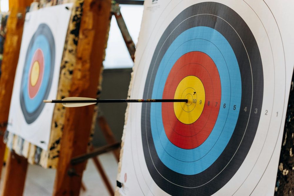 A photo of an arrow impaled in a target
