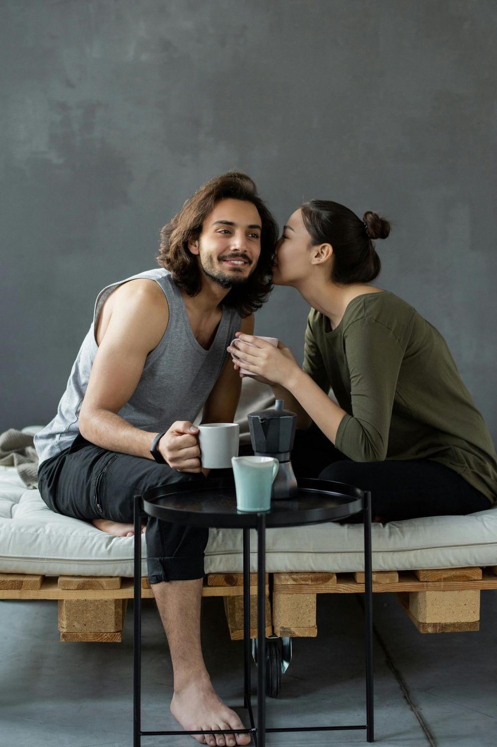 A photo of two people whispering