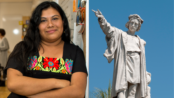 Indigenous woman standing and statue of Christopher Columbus