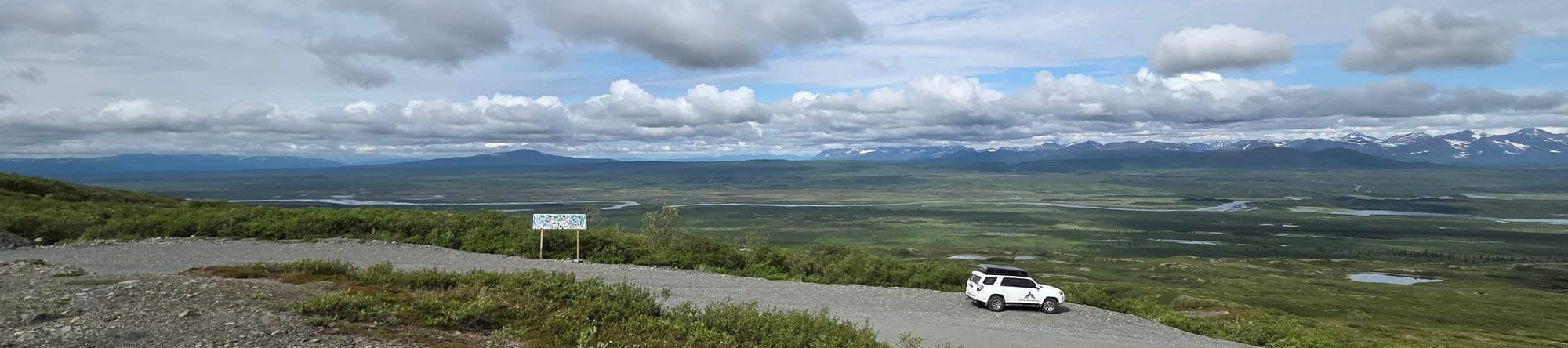 4Runner overlooking Alaska tundra with distant mountain range on Denali Highway