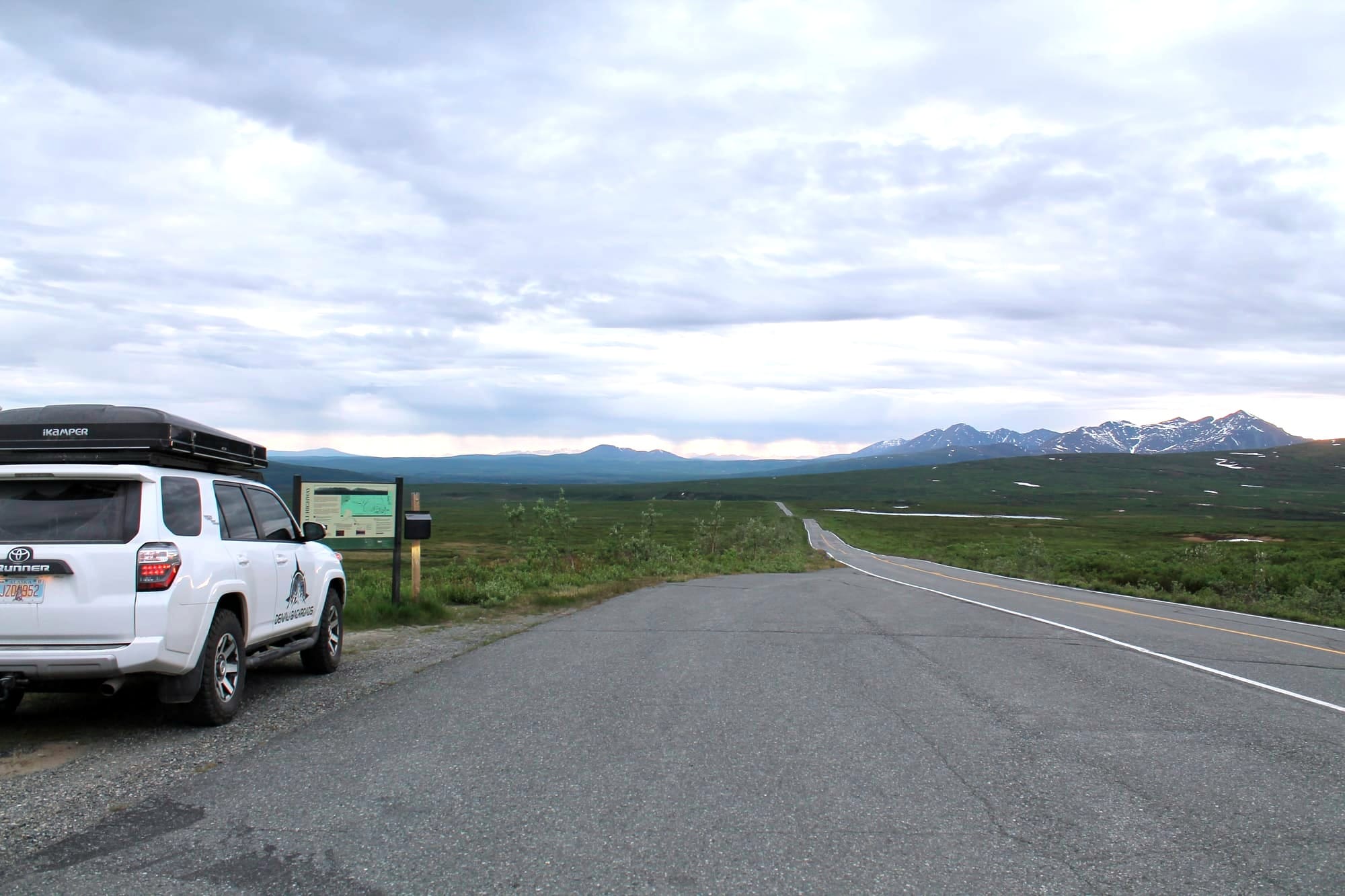 Denali Highway Alaska sign with road leading into tundra and mountains