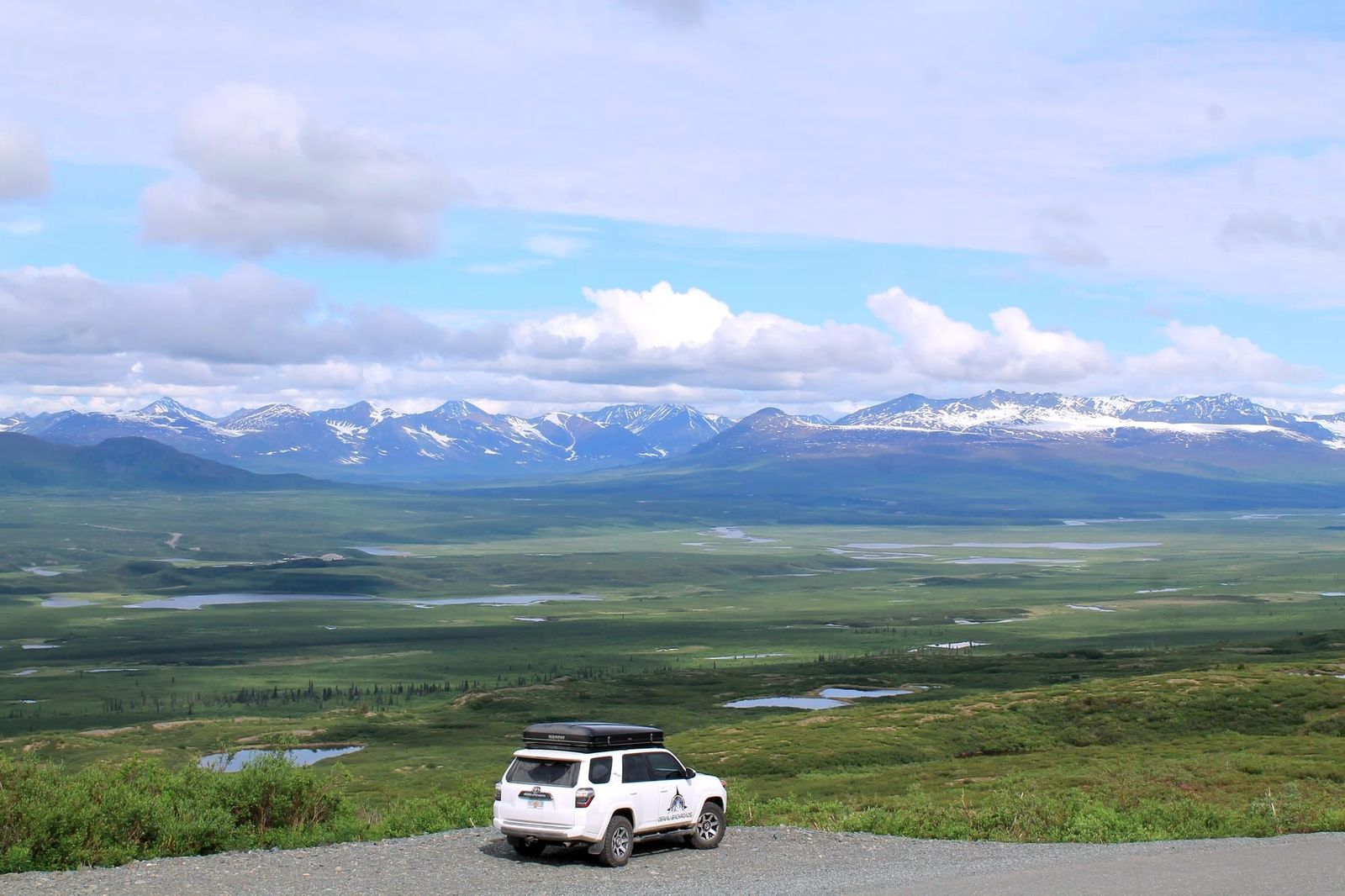 Denali Highway Alaska remote gravel road through tundra with Alaska Range mountain views