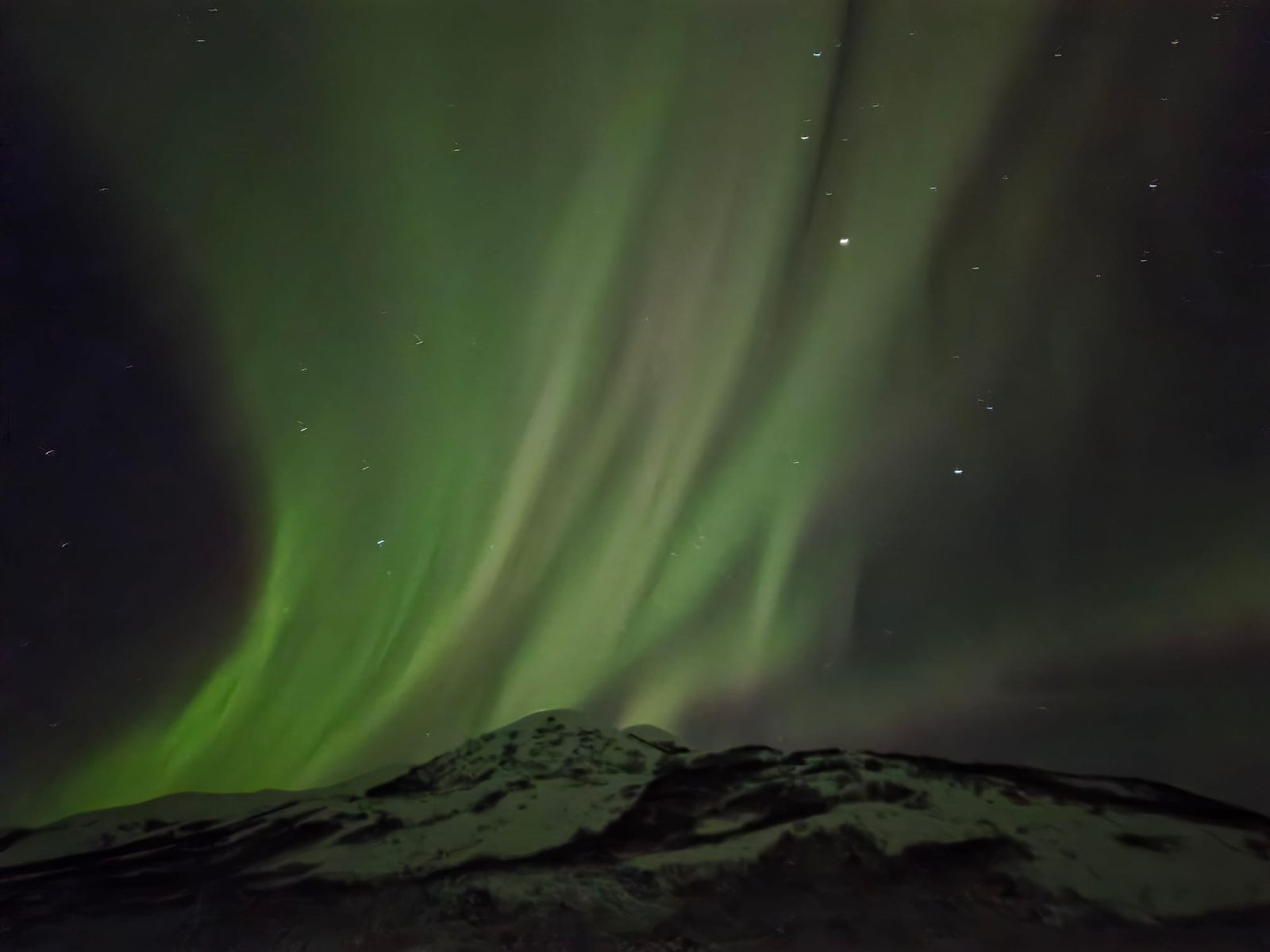 Northern lights near Paxon, Alaska with green aurora borealis dancing across the night sky