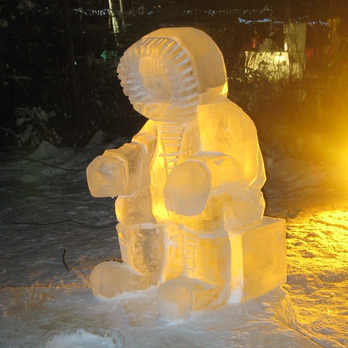 World Ice Art Championships in Fairbanks Alaska with large illuminated ice sculptures of an Eskimo sitting there at night