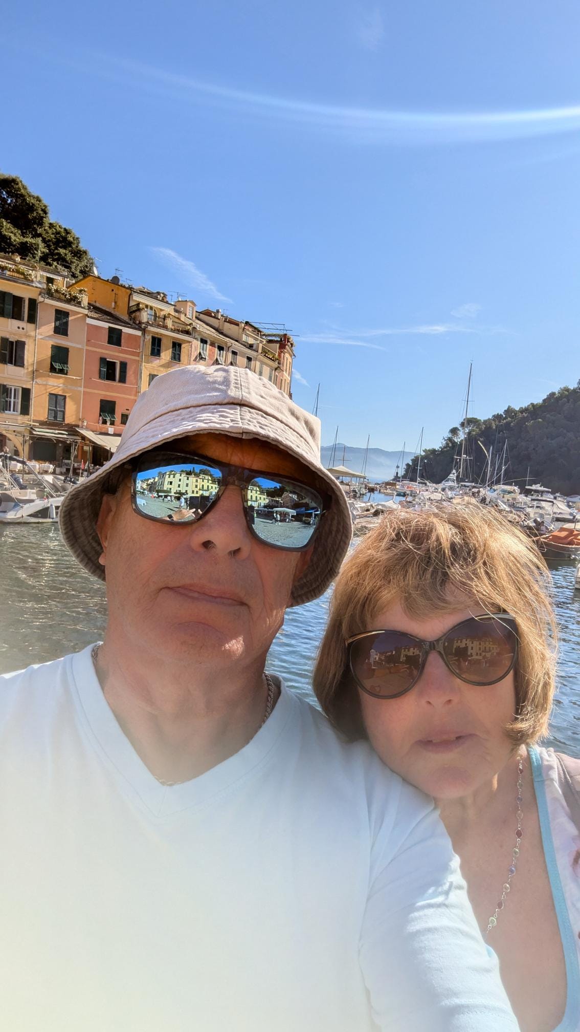 A selfie featuring a man and woman wearign sunglasses in the Mediterranean