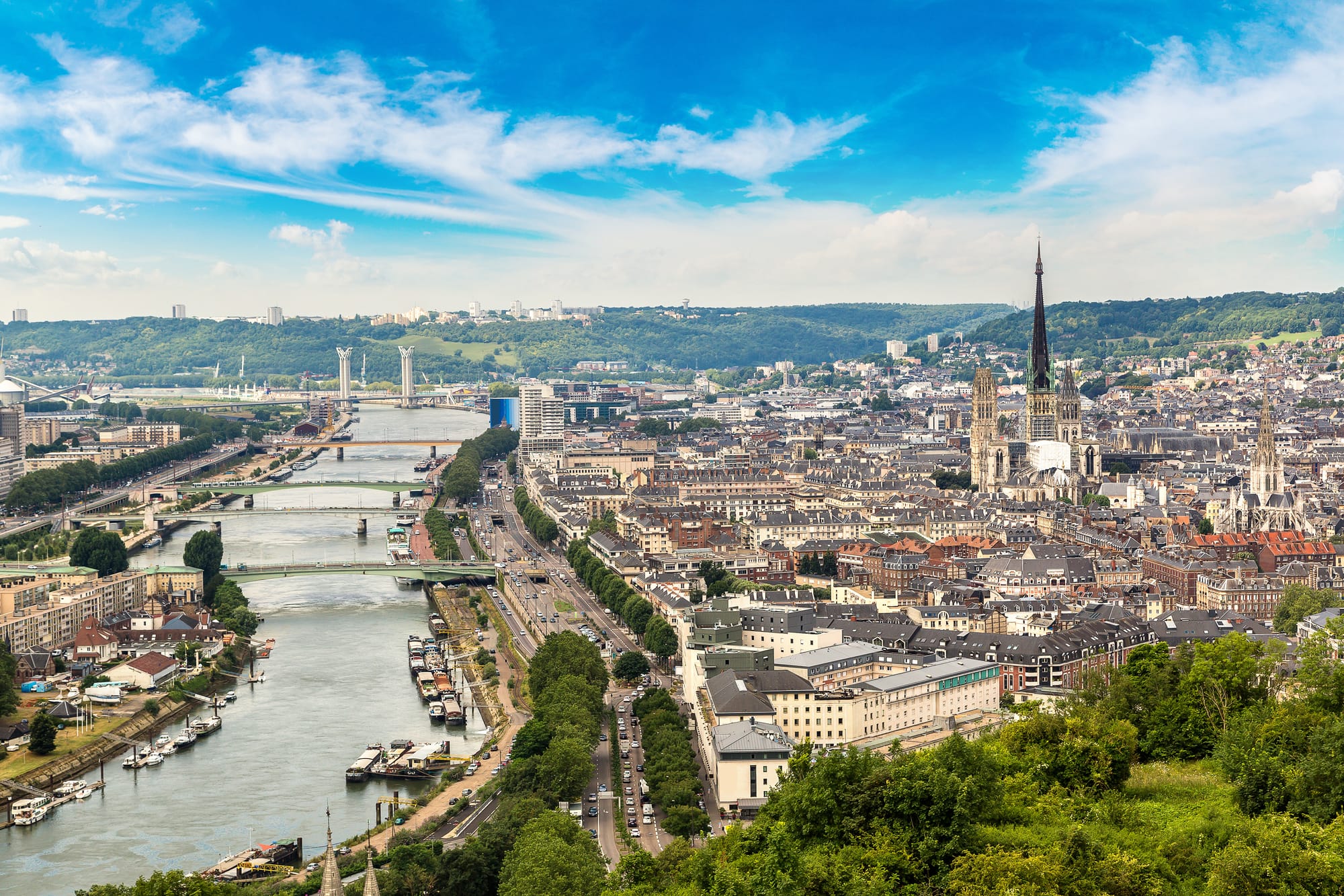 A panoramic view of Rouen from above with the Seine on the left of the city centre