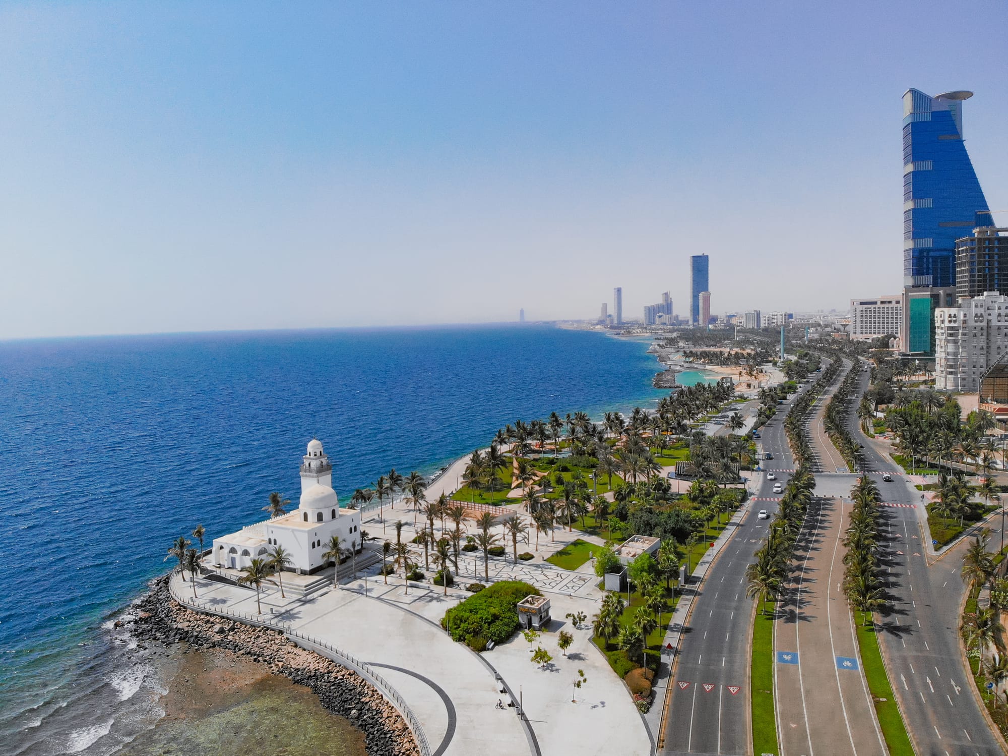 Jeddah seafront on a clear, sunny day, with motorways and modern skyscrapers