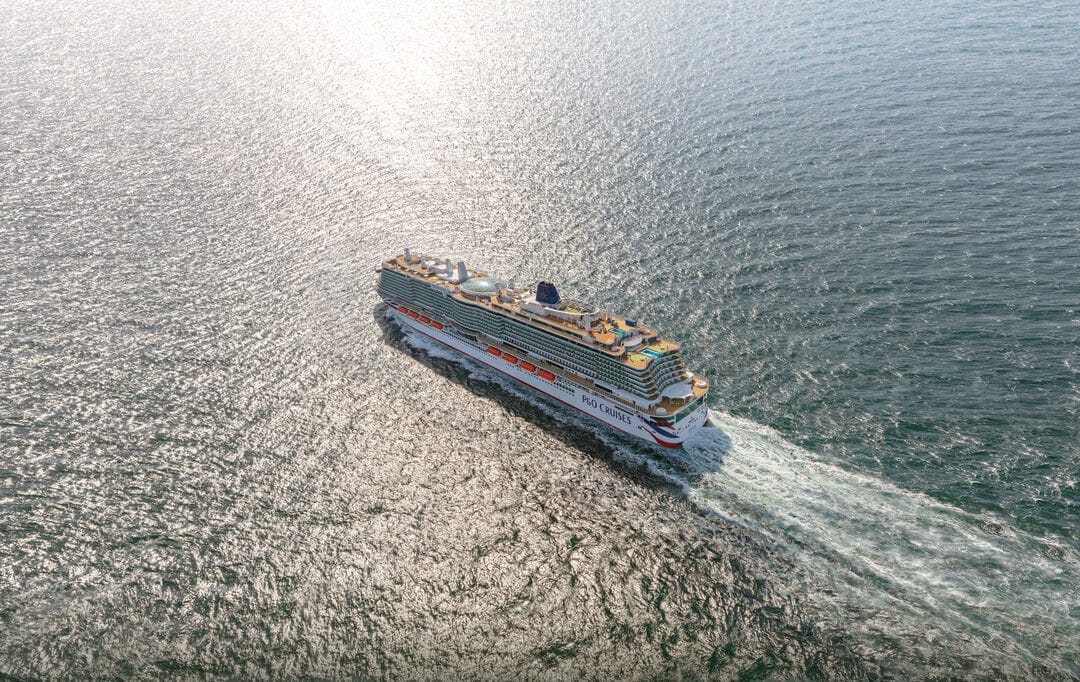 An image of a cruise ship from above sailing in open waters
