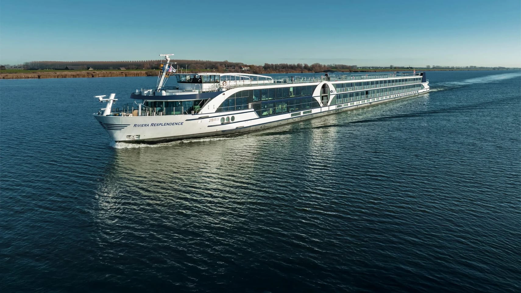 A river cruise ship sailing on a sunny day