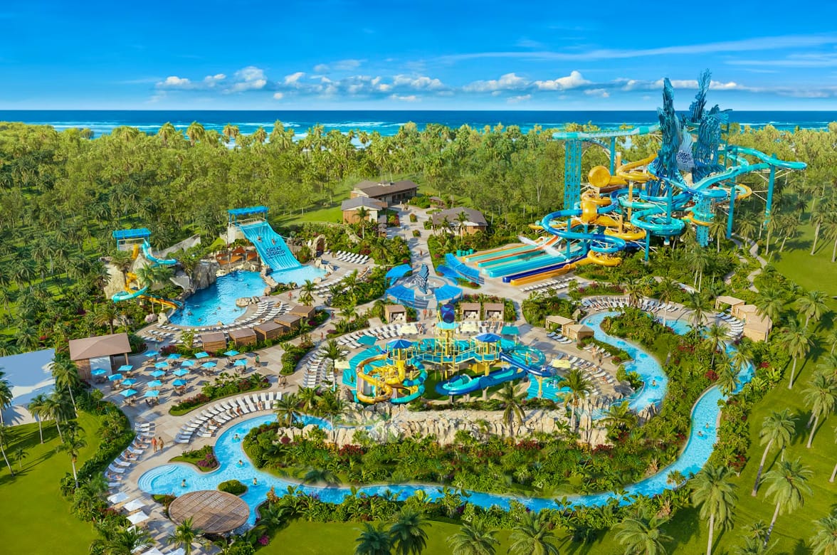 A render of a waterpark on a tropical island with a lazy river, several water slides, and sun loungers