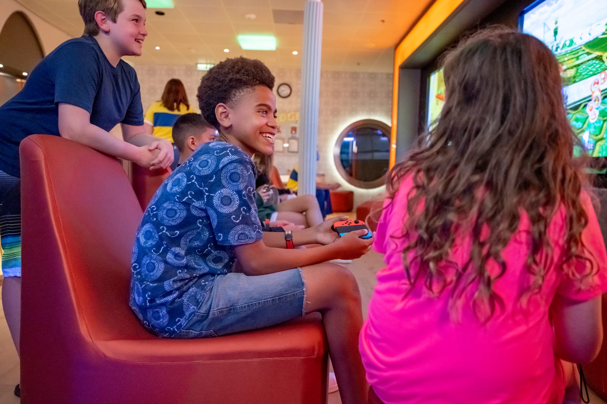 Teens in a lounge playing video games