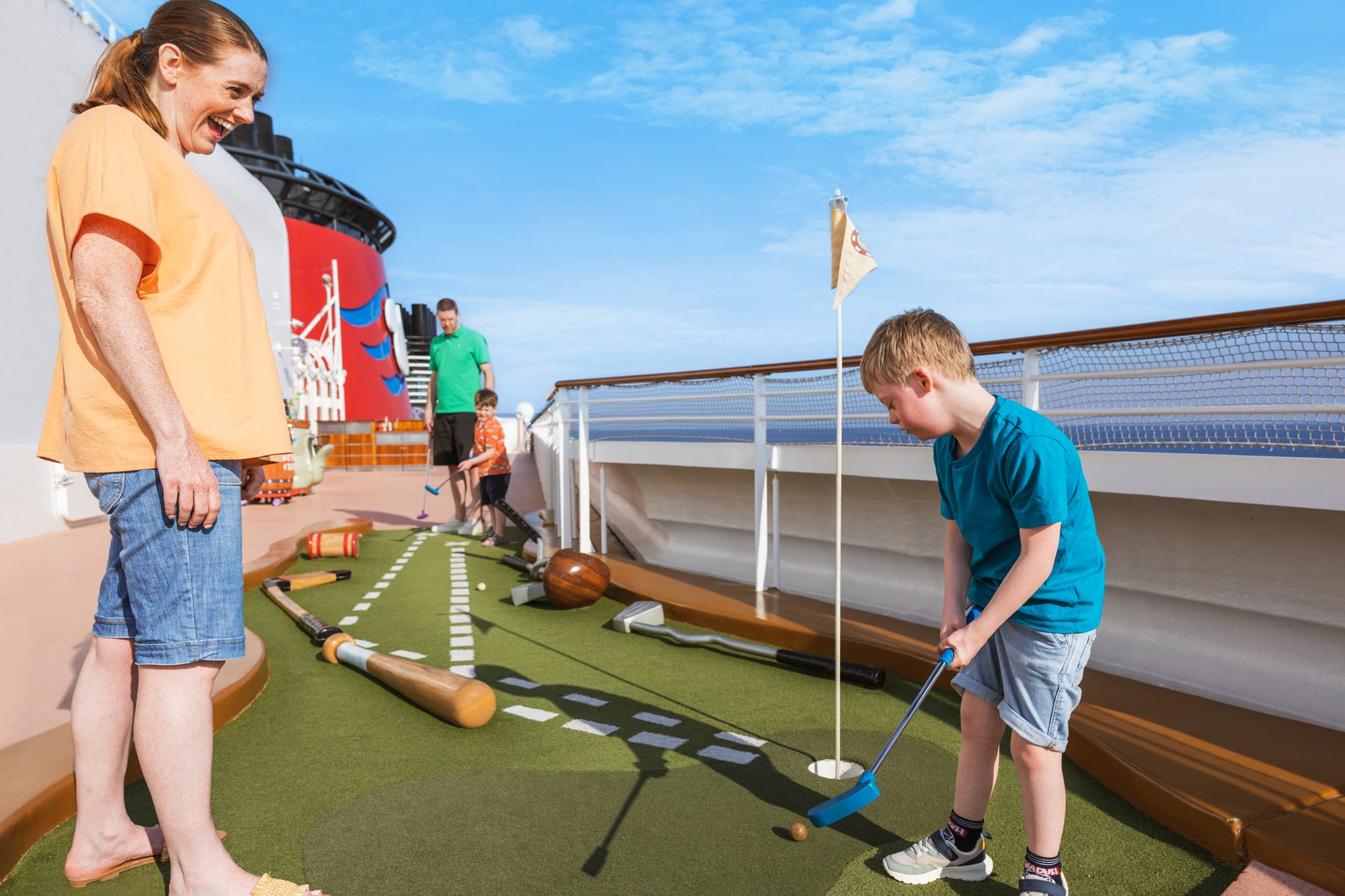 A family playing mini-golf