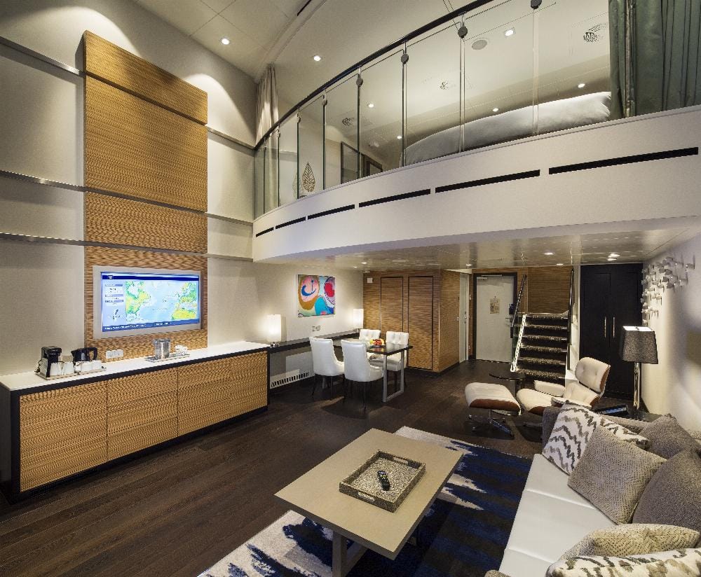 A two-story cabin with a bedroom upstairs and a living area below