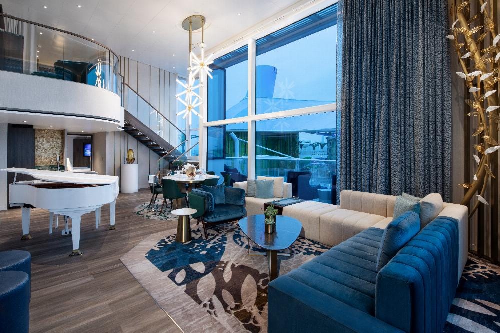 A large two-story cabins with a blue living area and a grand piano