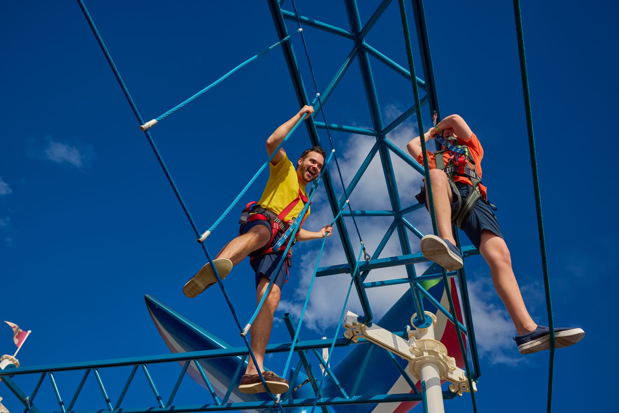 Two people on a ropes course from below