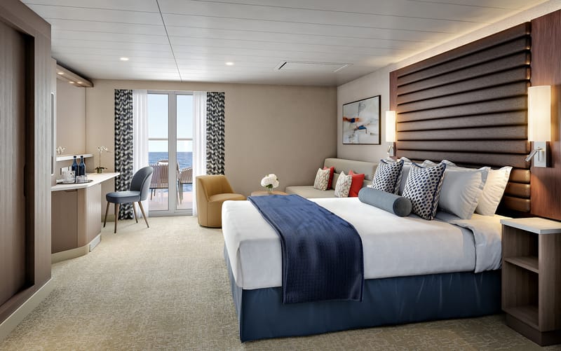 A large cabin with a double bed, a sofa, and a balcony area