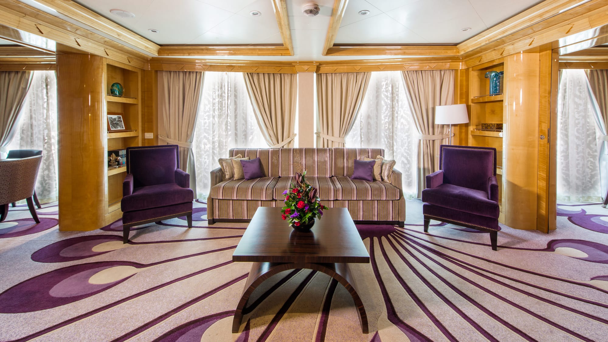 A spacious living space with a sofa and two armchairs
