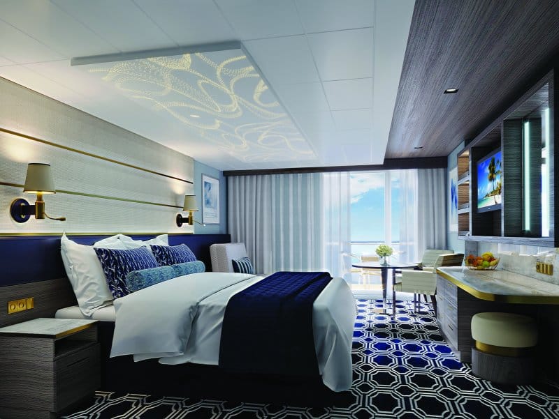A stylish room with a double bed, a chair, and a wide balcony