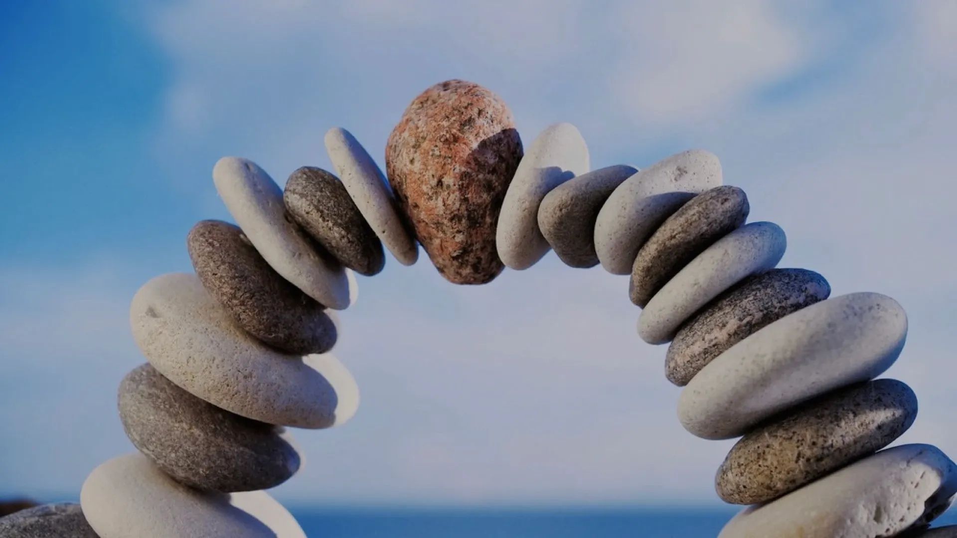 An arch of stacked stones on a beach