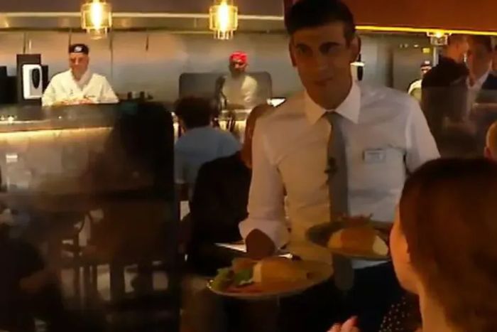 Rishi Sunak offers plates of food to people in restaurants as a virus rages