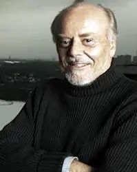 Tim Knight: a bearded man wearing a dark sweater, arms folded and smiling