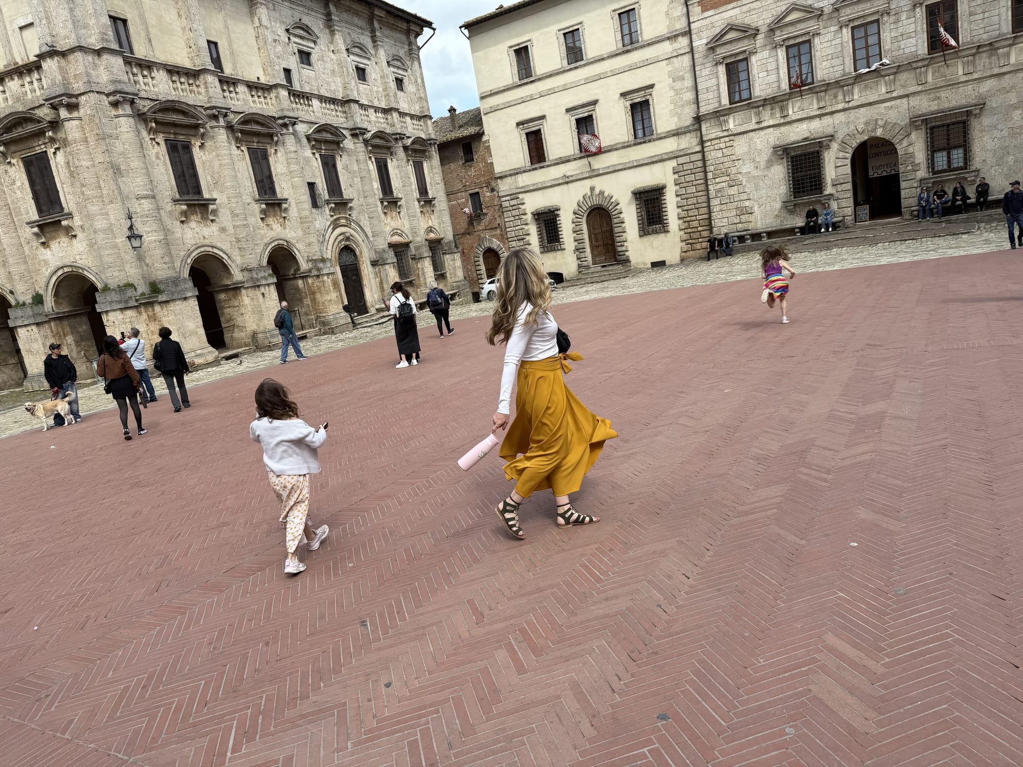 Jon's family walking through a historic Italian piazza