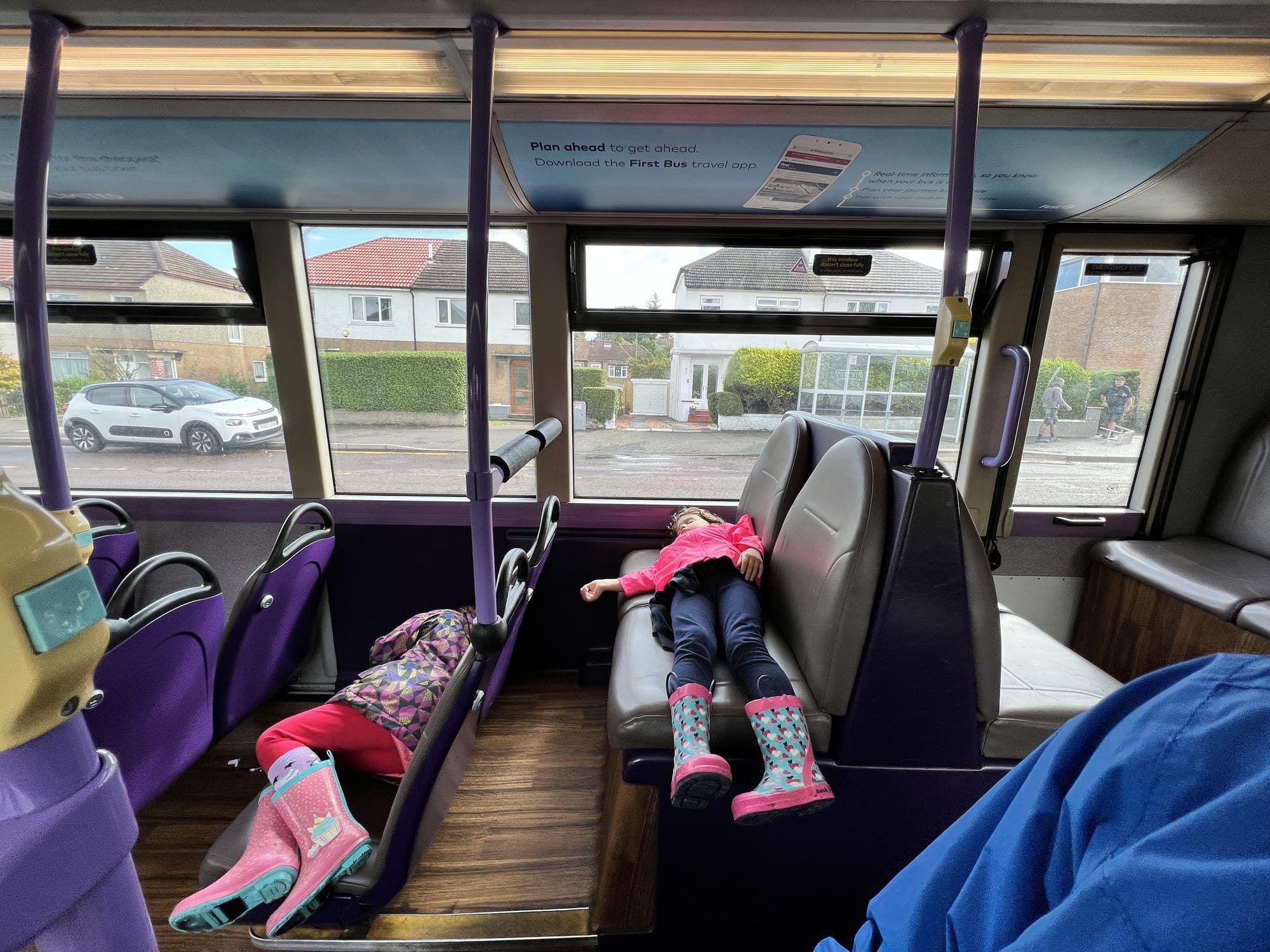 Inside a First Bus in Glasgow, with a First Bus travel app notice above the windows