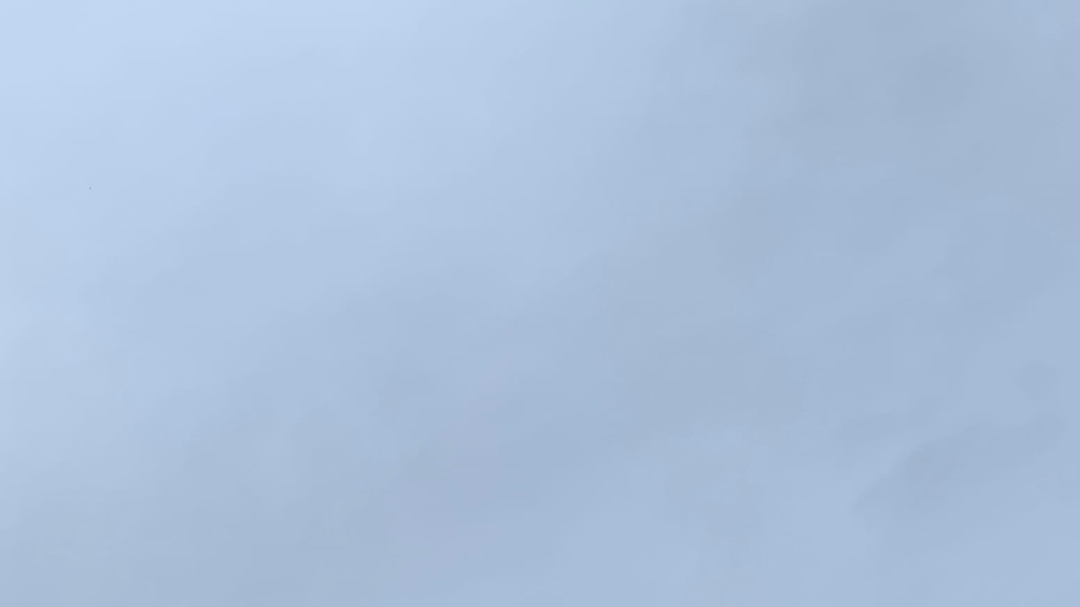 A patch of medium-gray sky with faint gradations of slightly darker medium gray on it.