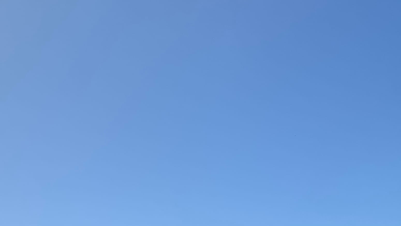 A patch of blue sky, slightly hazy.