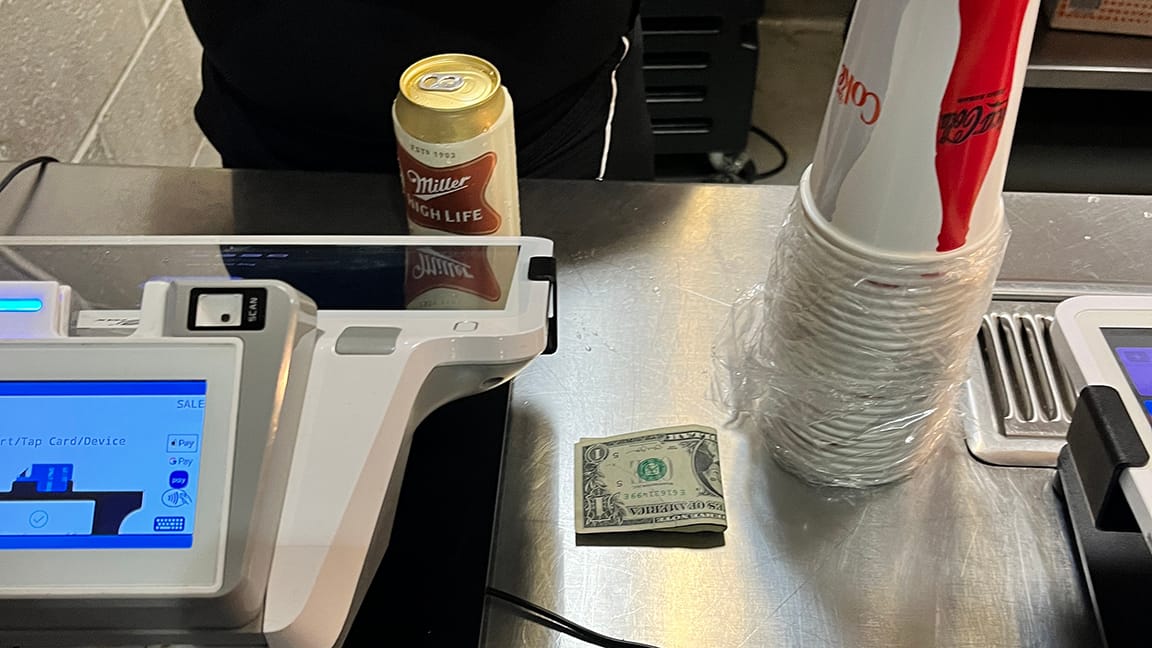 Counter of the stall near the register. My can of High Life and a cash tip.