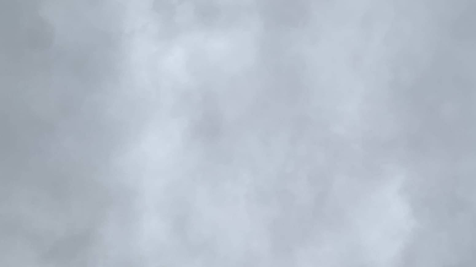 A cloudy, gray sky with portions of darker gray bracketing a mix of somewhat lighter grays in the middle. 