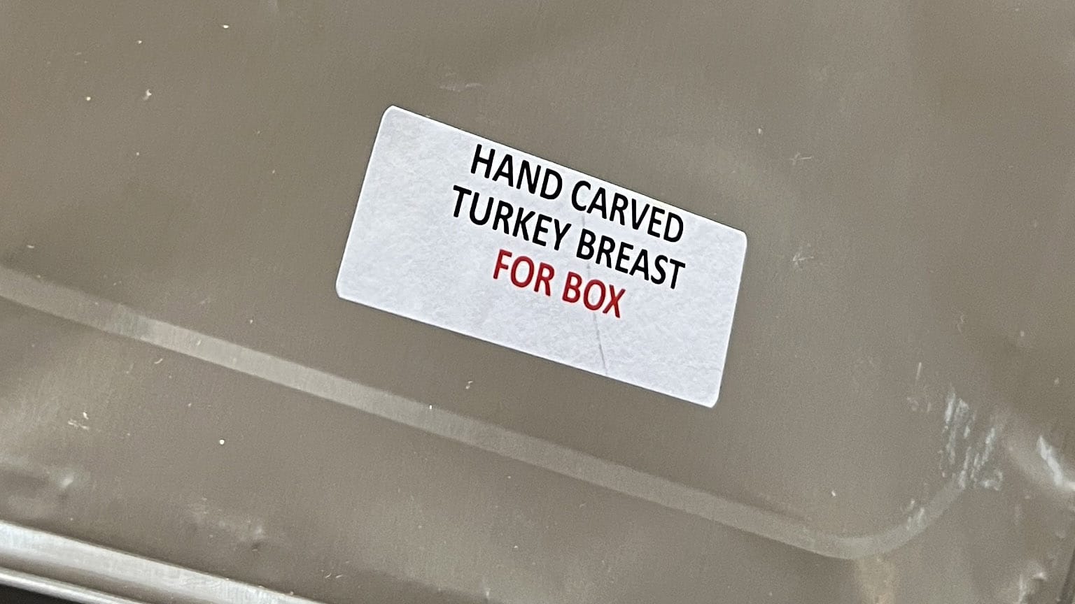 Sticker on foil container: HAND CARVED TURKEY BREAST *FOR BOX*