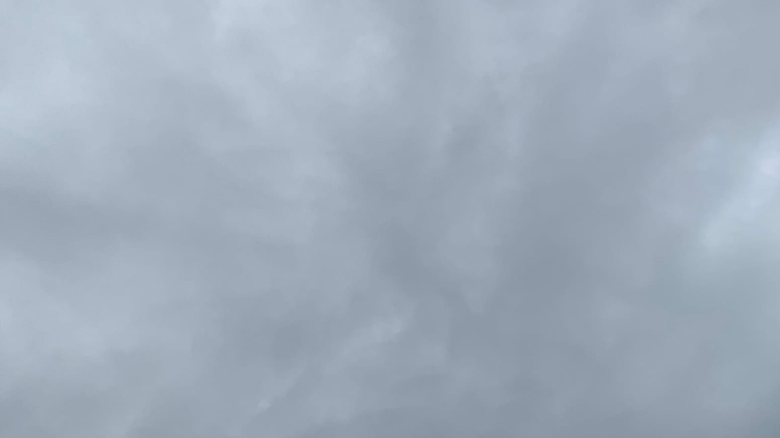 A patch of gray sky with lighter gray patches sort of vaguely radiating out from the center