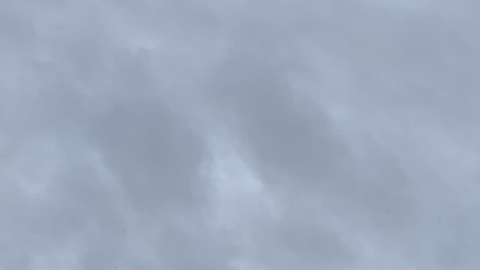 A patch of gray sky with some near-vertical patches of lighter gray running through it.