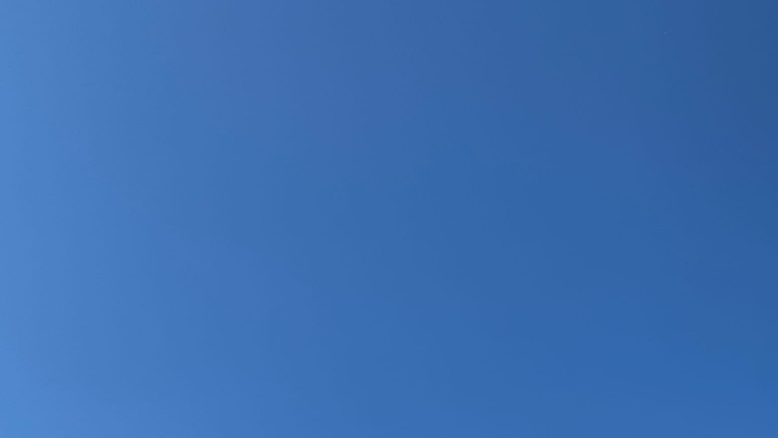 A patch of pure deep blue sky, slightly bluer as it goes from the left side to the right. 