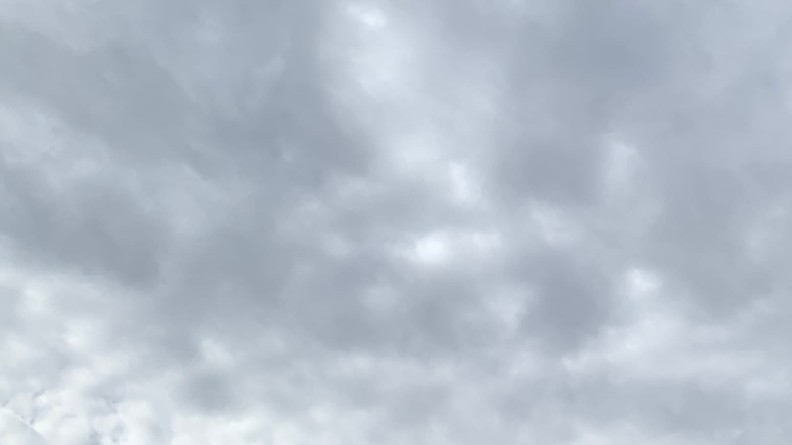 A patch of sky filled with brightly mottled gray cloud.