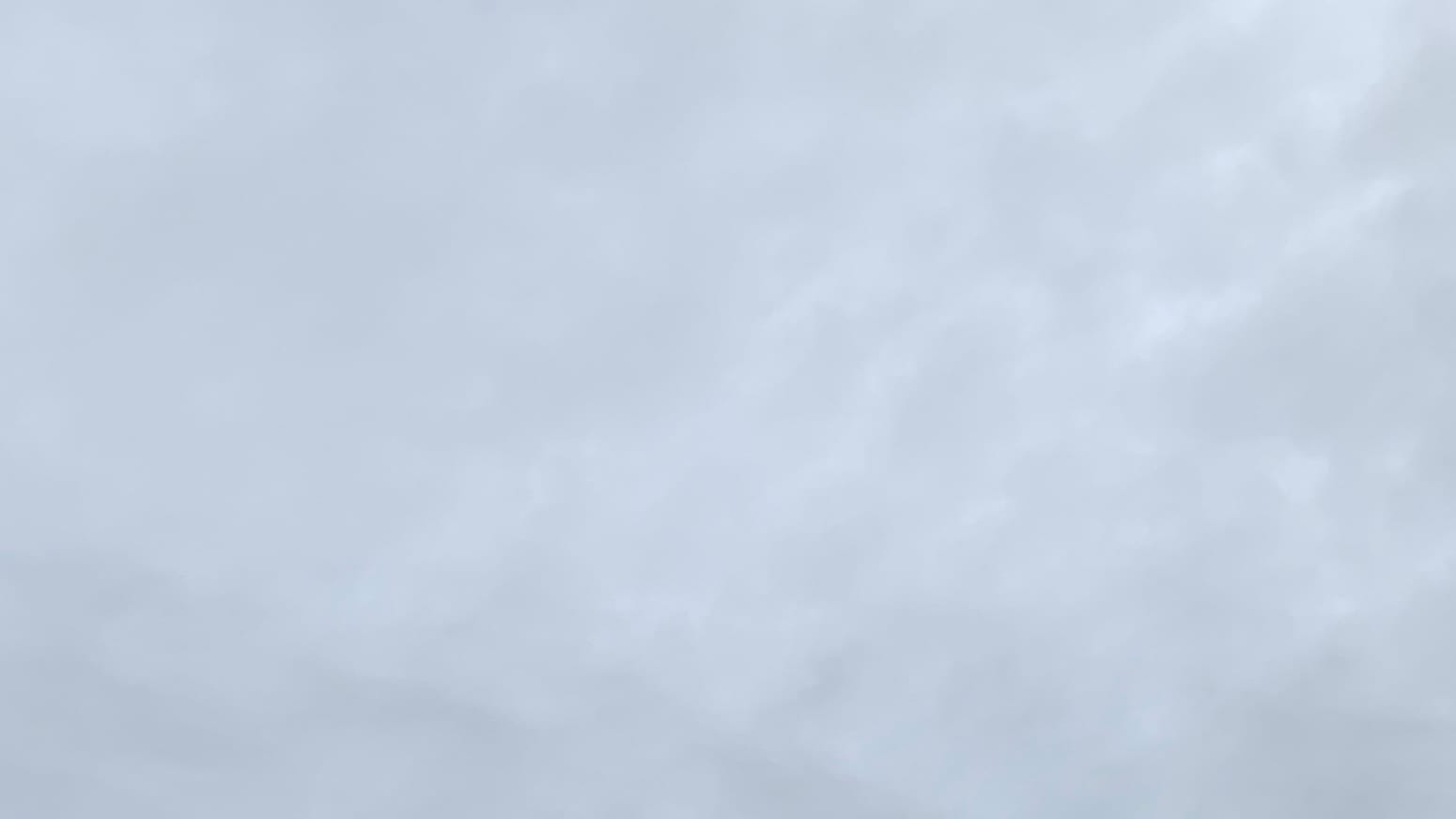 A patch of lightish gray sky mottled with still lighter gray bits. 