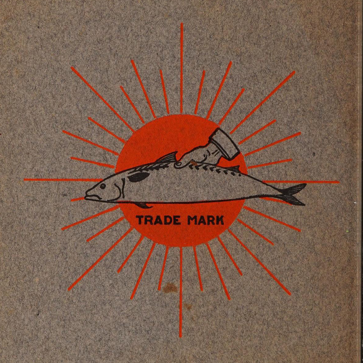 A hand holding a whole fish over a stylized red sunburst