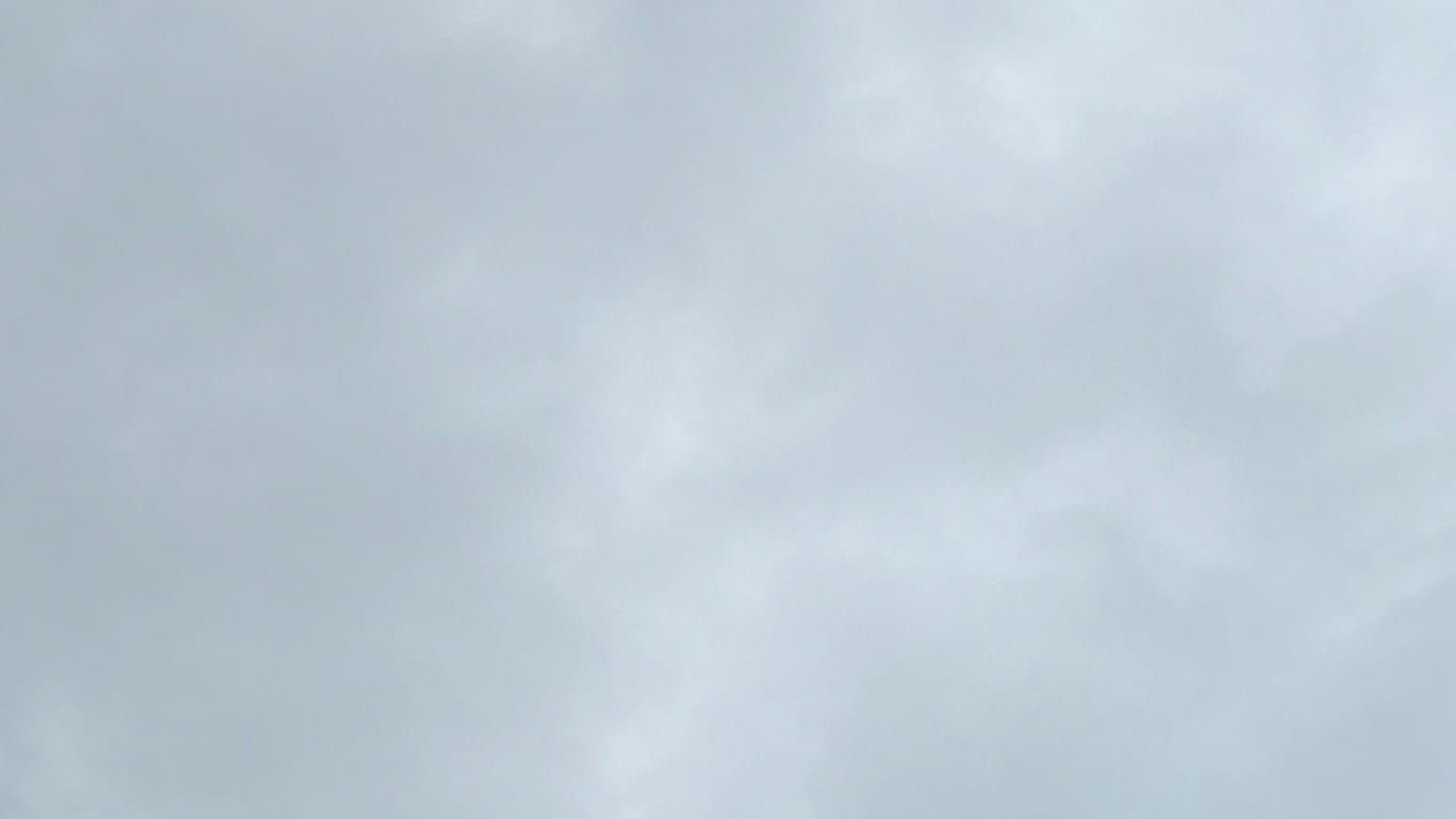  A patch of sky filled with cloud in indistinctly separated shades of medium gray