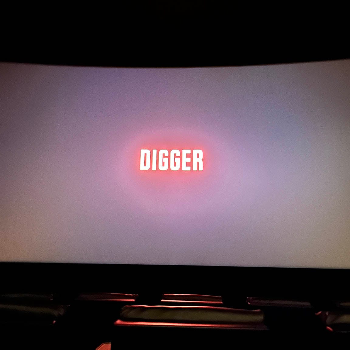 End title card in empty theater: DIGGER