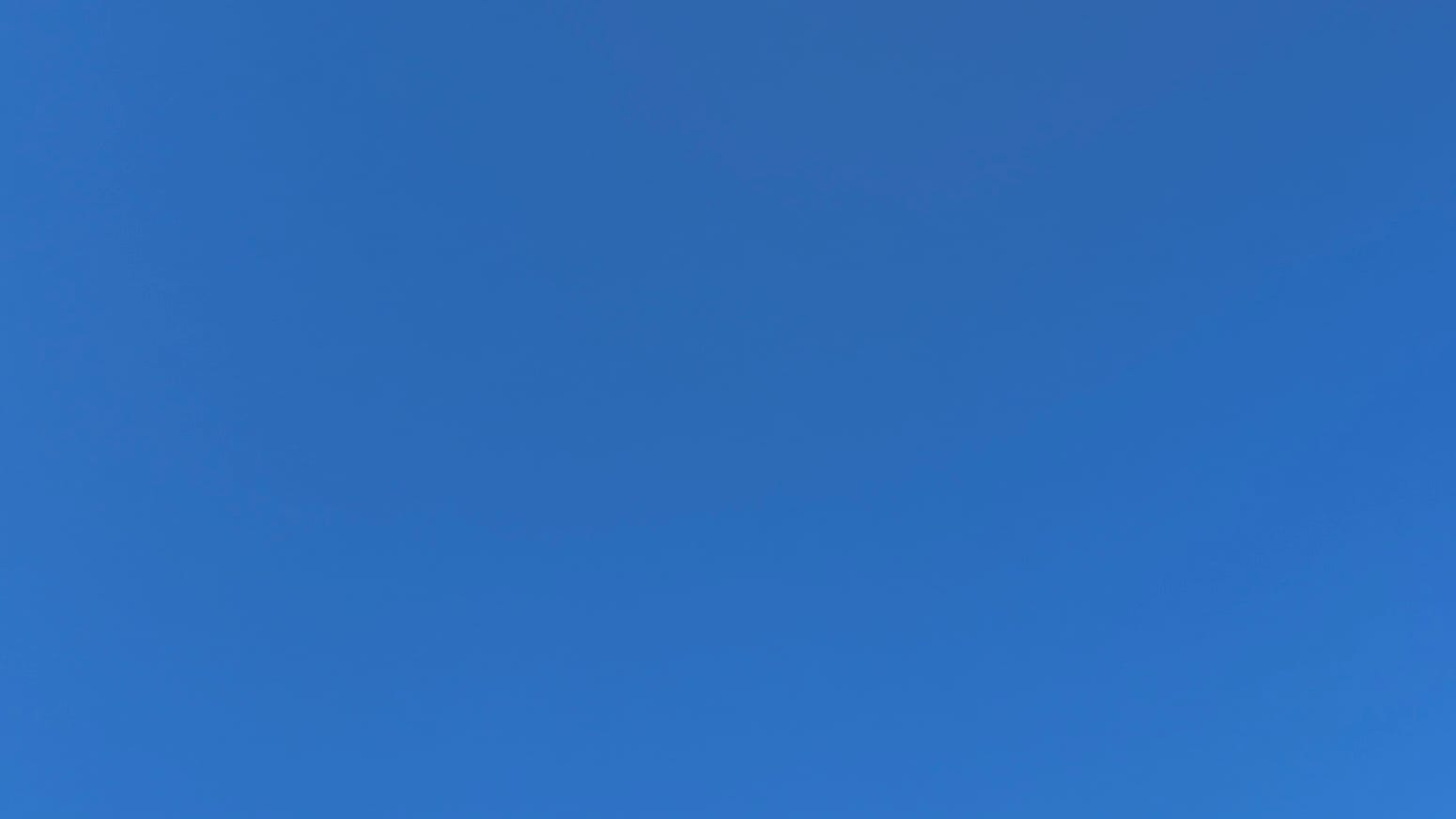 A patch of cloudless deep blue sky