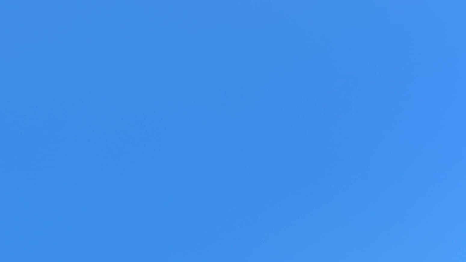 A patch of cloudless sky in a definitive sky-blue blue