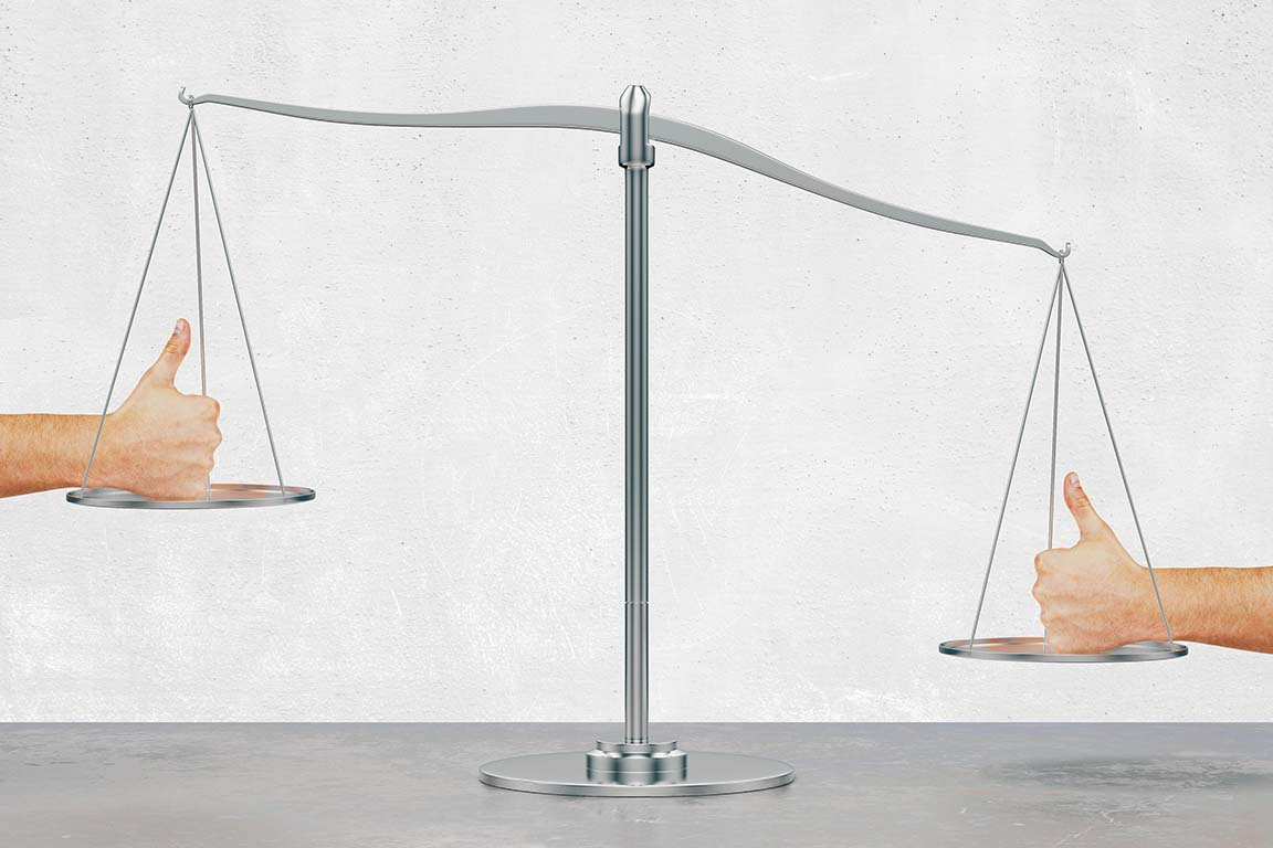A scale with a hand doing "thumbs up" gesture opposed by another hand also doing a "thumbs up" on the other side of the scale but weighing more even though they look the same